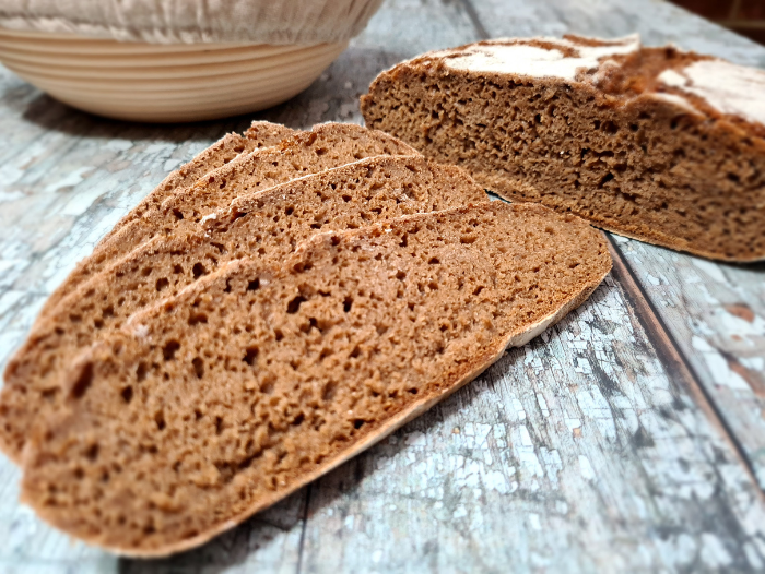 A loaf of Russian rye bread partly sliced