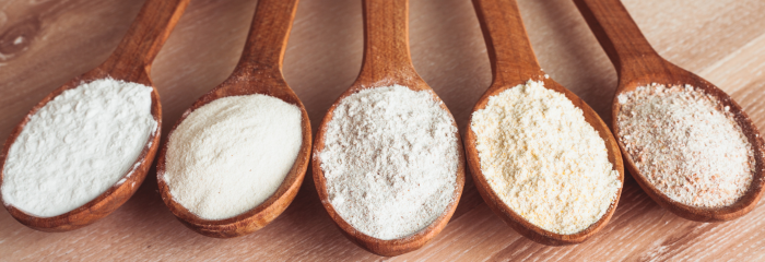 different types of flour in wooden spoons