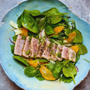 Gut-healthy seared tuna sliced and layered on a spinach, fennel and orange salad recipe