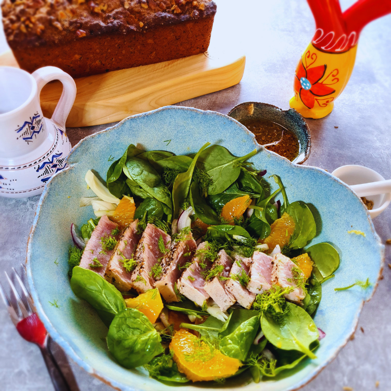 Bowl of seared tuna salad with spinach, fennel and orange