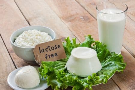 Dairy products such as milk, and cheese with the words “Lactose Free” — representing digestive enzyme deficiency as one of the causes of bloating beyond food choices.