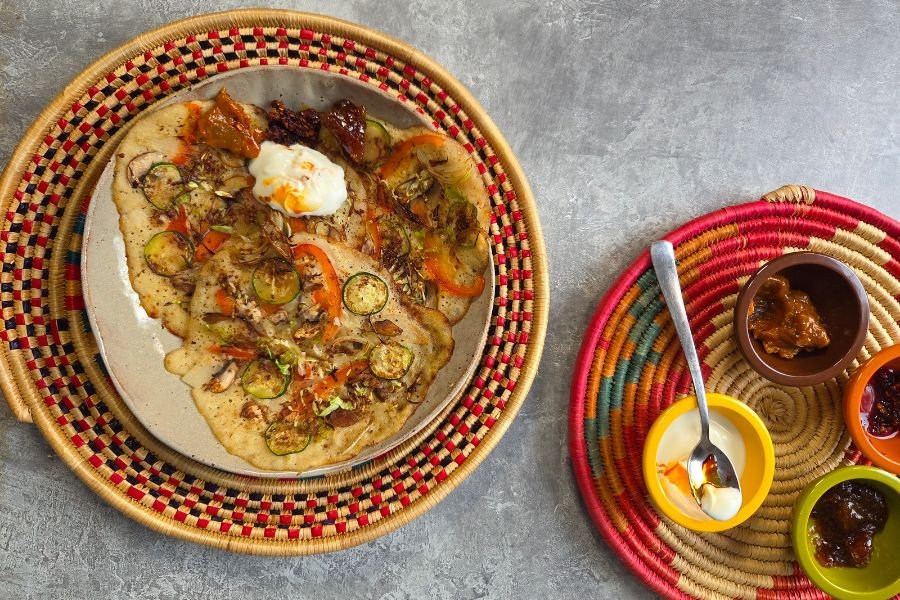 800x800 A plate of uttapam served with a selection of pickles, chutney and yogurt